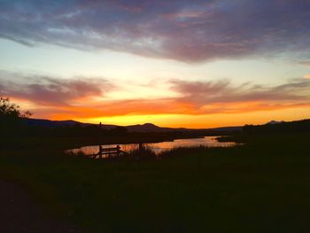 Scenic view of lake against sky during sunset