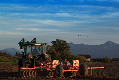 Tractor on field against sky