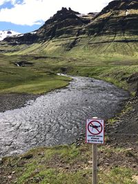 Road sign against mountain