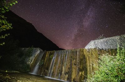 Full frame shot of dam against sky at night