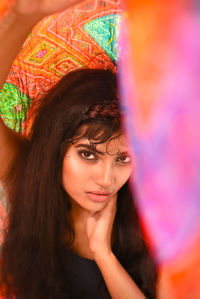 Portrait of young woman holding textile