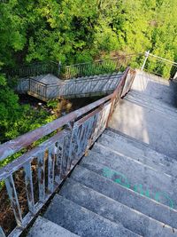 High angle view of bridge over footpath by trees