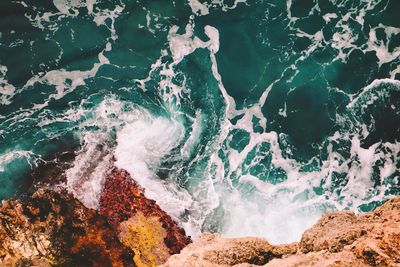 Waves splashing on rocks at shore