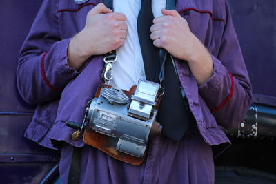 Close-up of man holding mobile phone