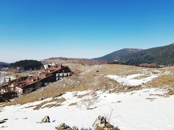 Scenic view of mountains against clear sky during winter