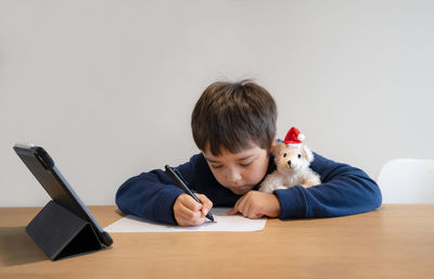 Portrait of boy holding table