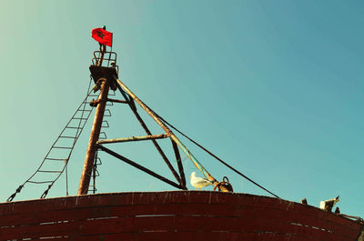 Low angle view of red tower against clear blue sky