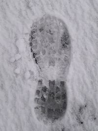 High angle view of footprints on snow covered field