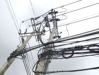 Low angle view of electricity pylon against clear sky