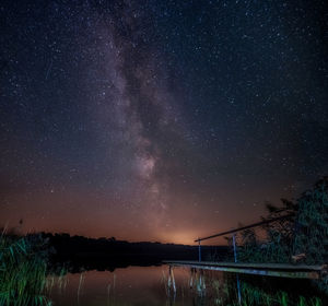 Scenic view of lake against star field at night