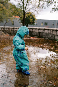 Side view of boy standing in lake