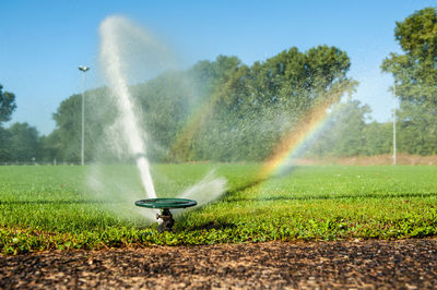 Scenic view of waterfall on field