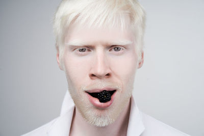 Portrait of mature man against white background