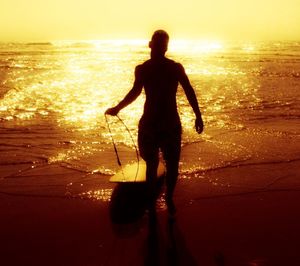 People on beach at sunset