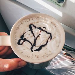 Cropped image of person holding coffee cup