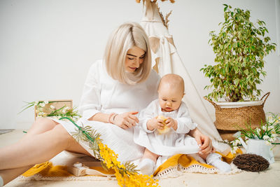 Portrait of young woman sitting at home