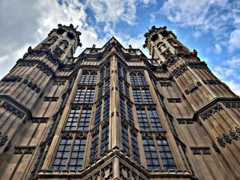 Low angle view of building against cloudy sky