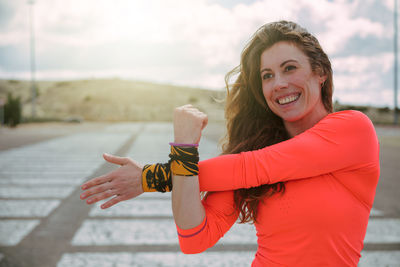 Portrait of smiling young woman standing outdoors