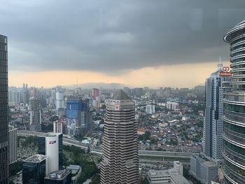 High angle view of modern buildings in city against sky