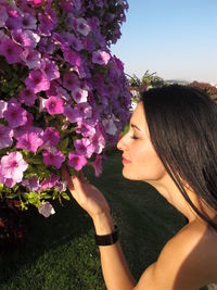 Close-up of woman with flower on tree