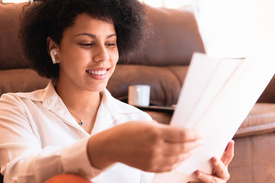 Portrait of young woman reading book