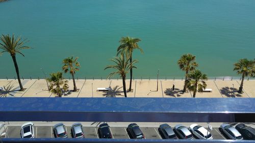 Swimming pool by sea against blue sky