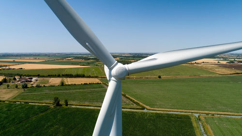 Windmill on field against sky