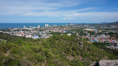 High angle view of townscape by sea against sky
