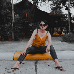 Portrait of young woman sitting outdoors