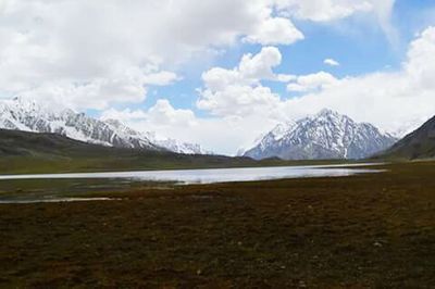 Scenic view of lake against cloudy sky