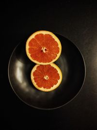 Directly above shot of orange fruit against black background