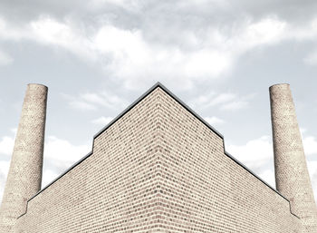 Low angle view of building against cloudy sky