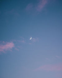 Low angle view of moon in sky at night