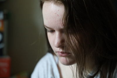 Close-up portrait of a young woman looking away