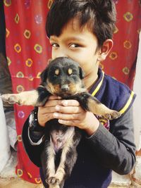 An indian child in love with puppy
