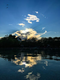 Scenic view of lake against sky at sunset