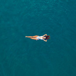 High angle view of man swimming in sea