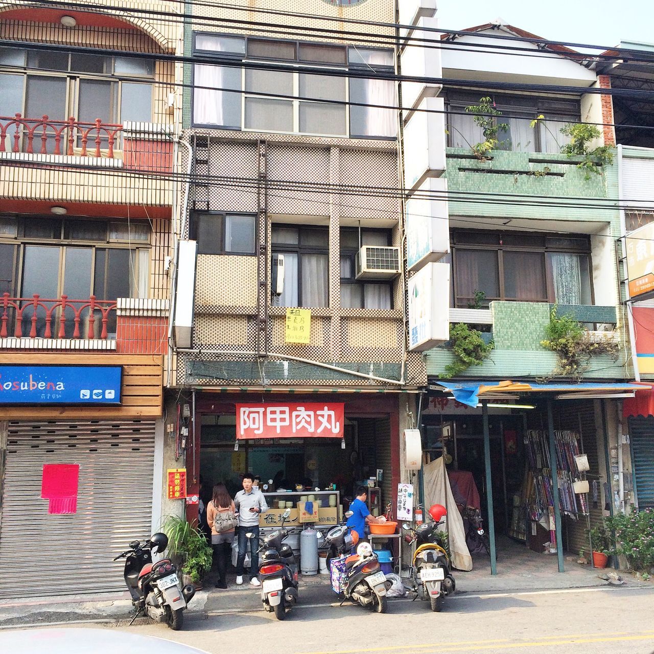 building exterior, architecture, built structure, text, men, city, market, street, store, person, retail, western script, transportation, city life, communication, market stall, lifestyles, mode of transport, non-western script