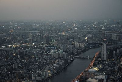 Aerial view of river amidst buildings in city