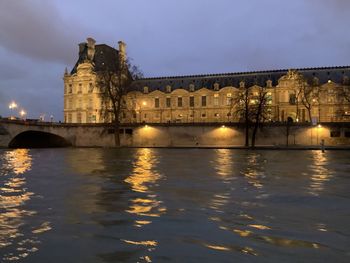 Reflection of illuminated buildings in water at night