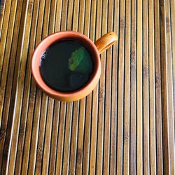 High angle view of tea cup on wooden table