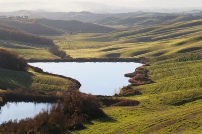 Scenic view of landscape and lake against sky