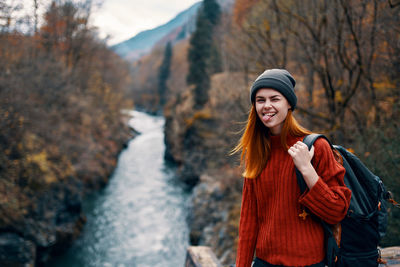 Young woman standing in forest during winter