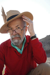 Portrait of senior man wearing hat at beach