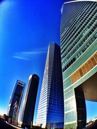 Low angle view of modern building against blue sky