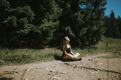 Young woman sitting on field