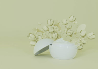 Close-up of white jar on table