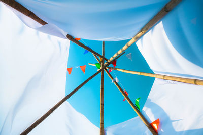 Low angle view of parasol against sky