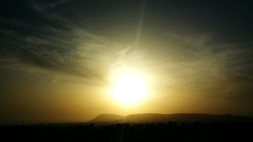 Silhouette landscape against sky during sunset