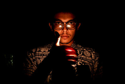 Portrait of mid adult man against black background